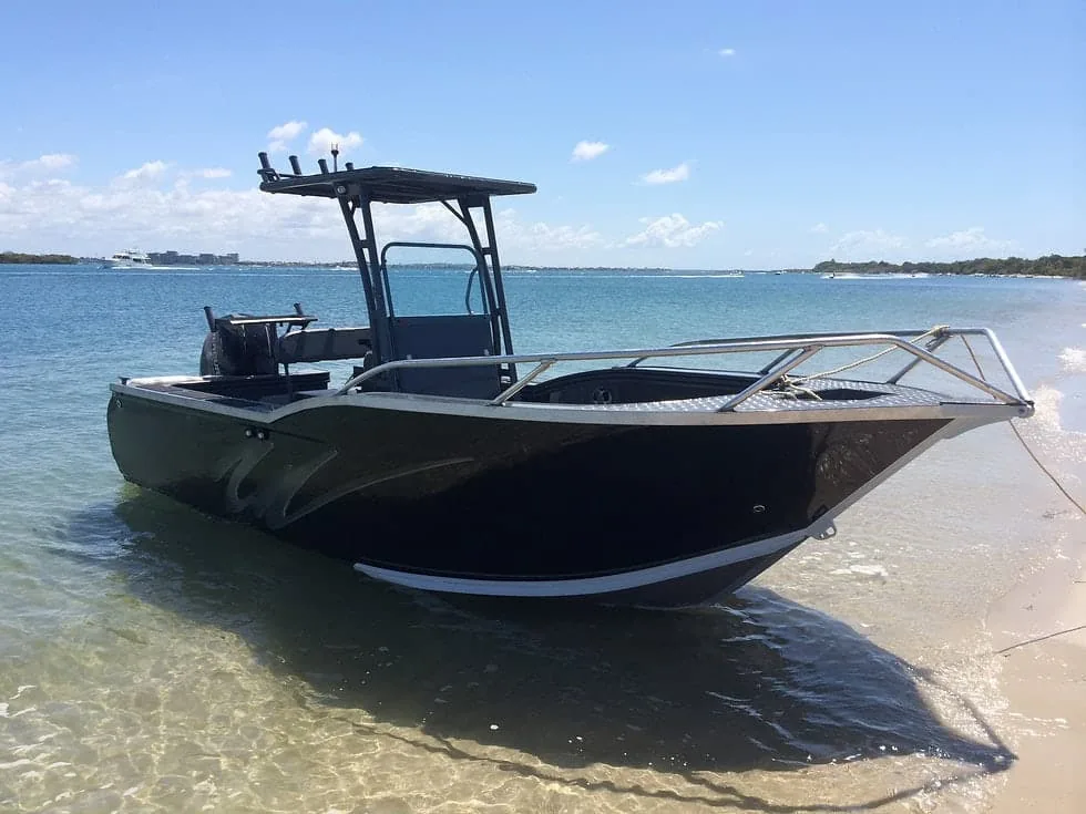 Current 18 aluminum center-console fishing boat with a T-top in shallow water