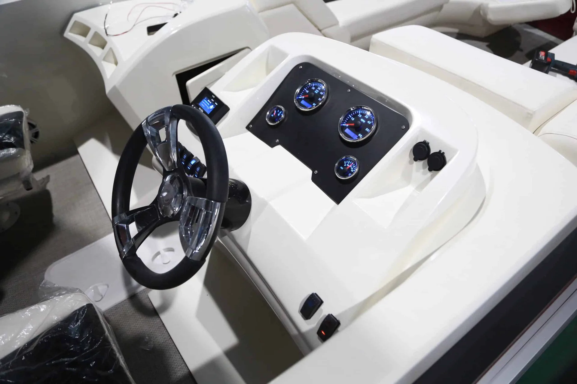 Pontoon helm with a steering wheel, gauges and switches from the source range